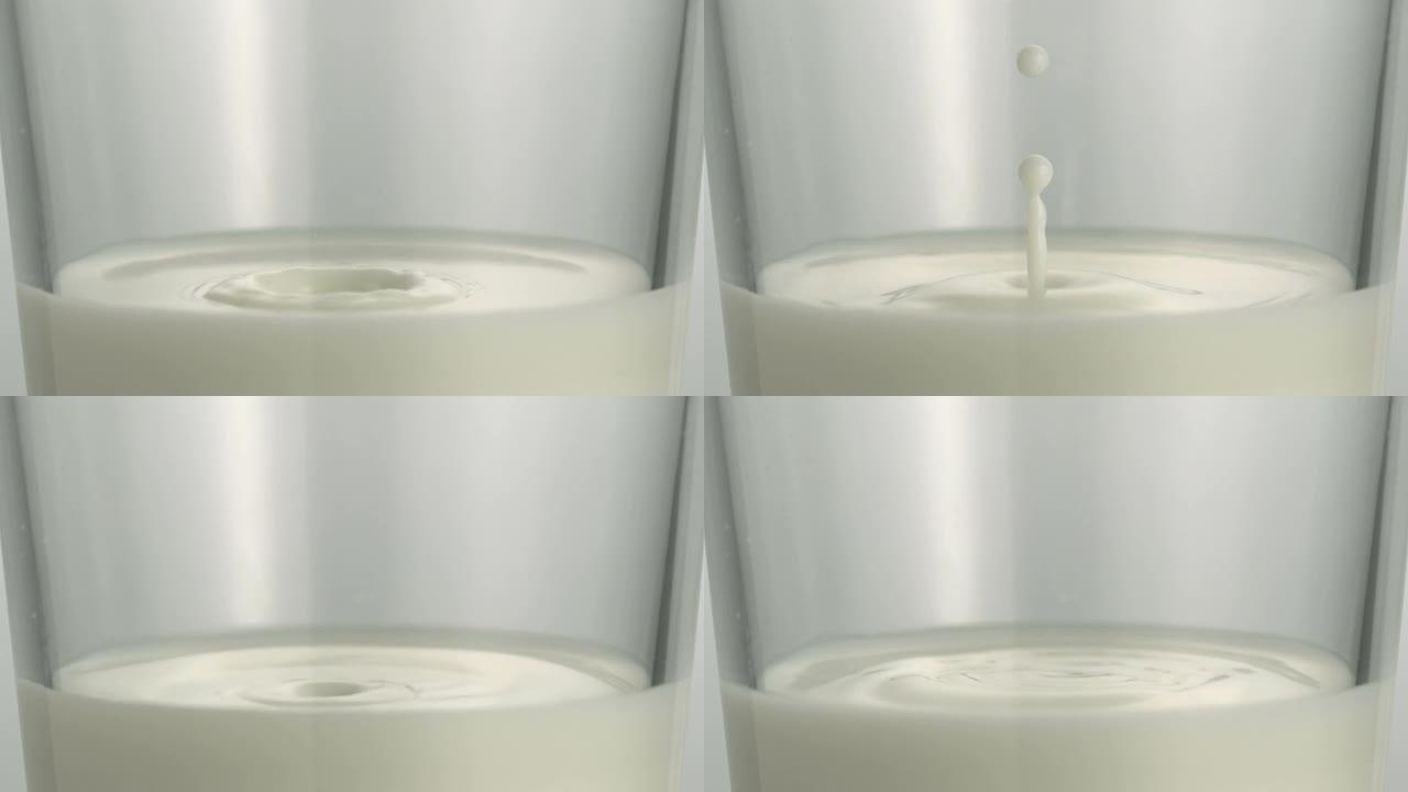 滴牛奶和波纹在玻璃杯中，慢动作