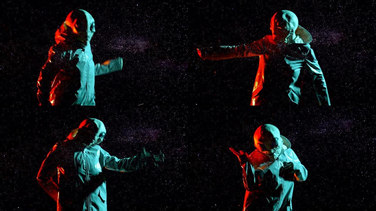 未来的外星人在星空空间、天空背景上跳舞。霓虹灯外星星球上人形动物的有趣模因镜头，伪装成穿着光滑雨衣的