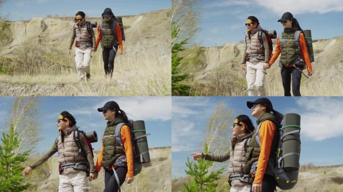 两个亚洲女性朋友牵手行走在大自然、风和阳光中