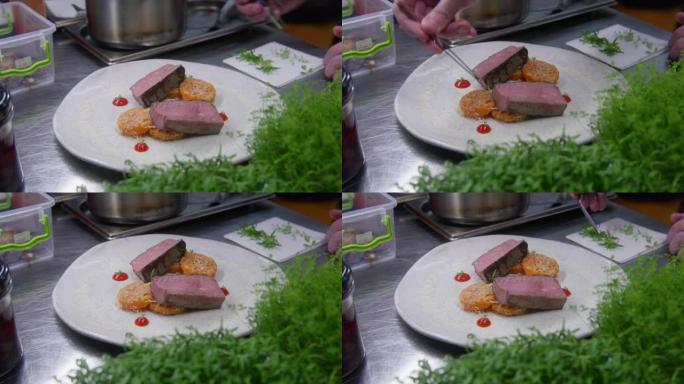 厨师使用厨房镊子将微绿放在盘子上