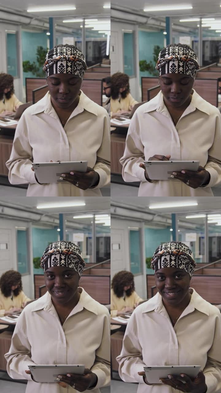 非裔美国妇女在办公室平板电脑工作的肖像