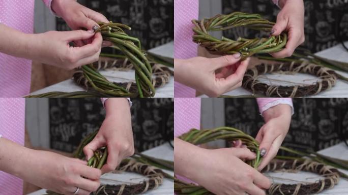 一名妇女检查用藤蔓编织的自制花环。固定柳条的末端。特写。