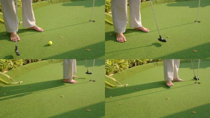 在人造草皮上打高尔夫球。