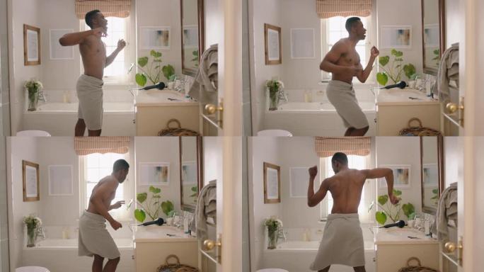 快乐的非洲裔美国男子在浴室光着膀子跳舞，照镜子，享受早晨的例行活动，准备享受积极的自我形象，做愚蠢的