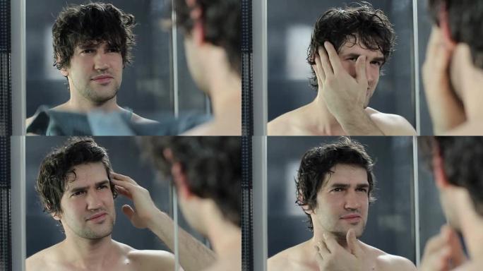 男子在镜子旁用毛巾擦拭头发