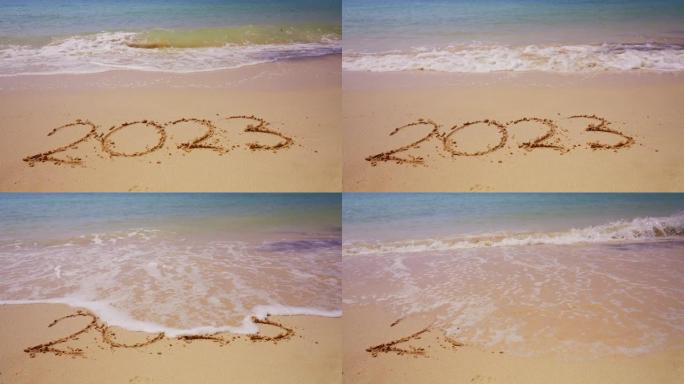 海浪冲走蚀刻在沙子上的2023