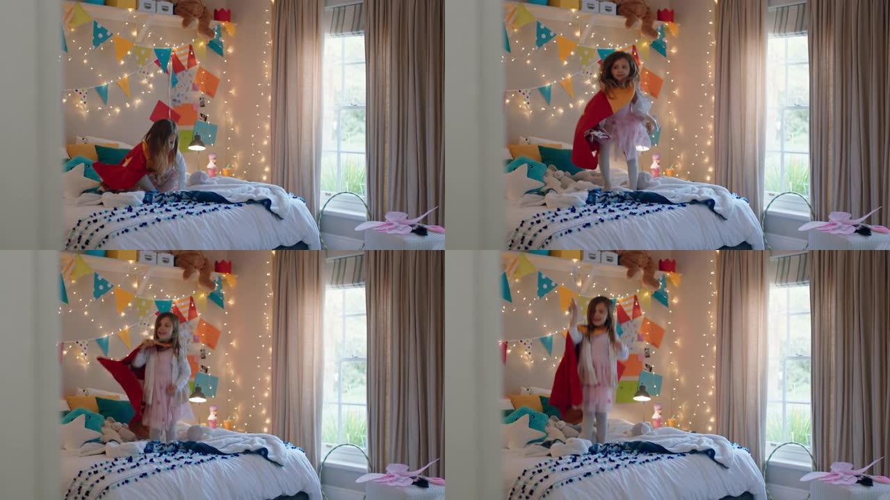 快乐的小女孩穿着戏服跳上床在家里五颜六色的卧室里玩游戏享受嬉戏的想象力