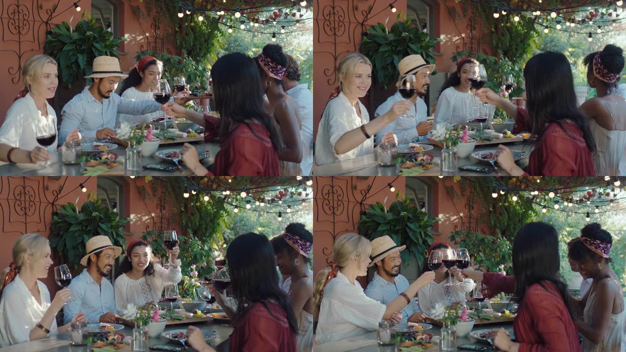 朋友敬酒庆祝晚宴喝酒吃地中海食物坐在餐桌旁享受美丽的夏日户外4k镜头