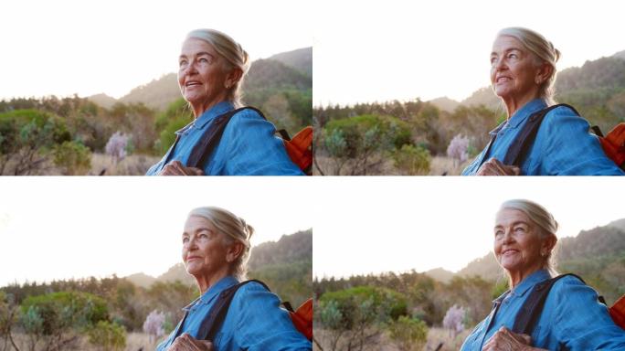 在乡村徒步旅行的活跃的老年妇女的特写肖像