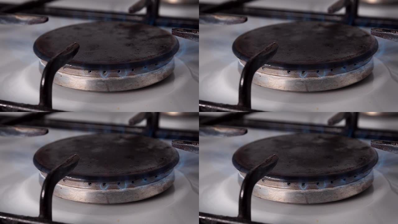 燃气燃烧器在厨房炉灶上用蓝色火焰燃烧。天然气在日常家庭生活中的使用。