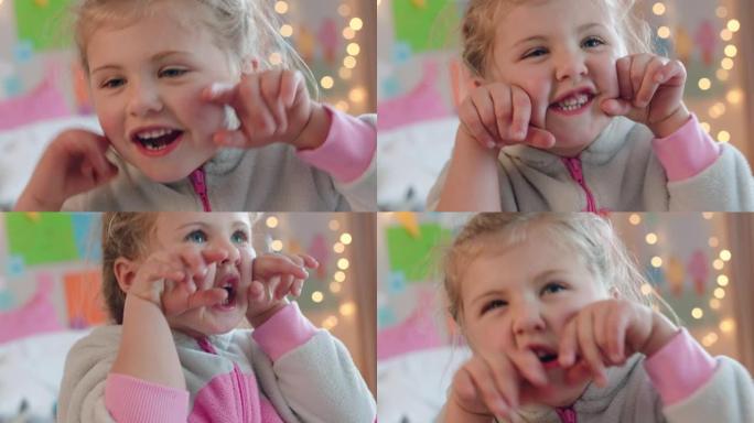 肖像小女孩做鬼脸微笑快乐的孩子享受童年在家里玩得开心
