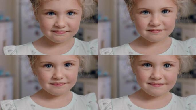 肖像美丽的小女孩微笑着看着相机，表情可爱