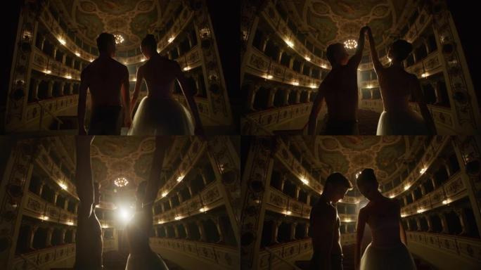年轻的古典芭蕾舞演员夫妇以戏剧性的灯光进入经典剧院的舞台的电影镜头。男女舞者在演出前一起排练表演
