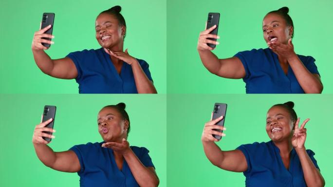 黑人妇女的自拍照被隔离在工作室背景或绿屏上，并带有社交媒体的吻，和平标志和表情符号。个人资料图片更新