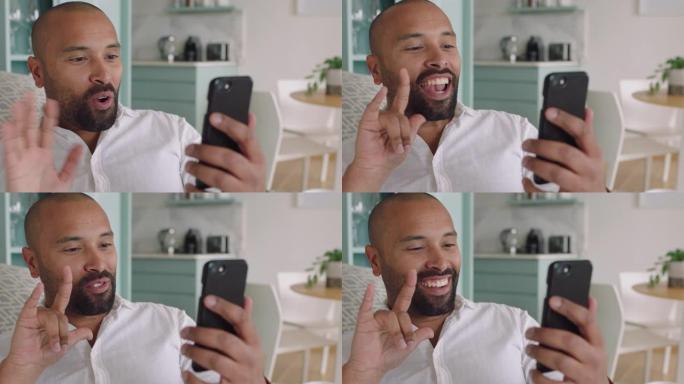 听力受损的男子在智能手机上使用手语进行视频聊天，挥舞着享受手机上的交流聊天