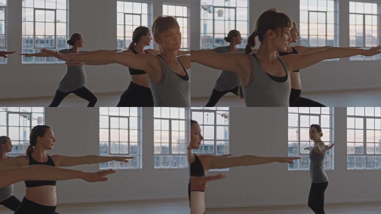 瑜伽课教练在日出时在健身室教健康孕妇练习战士姿势享受团体训练锻炼