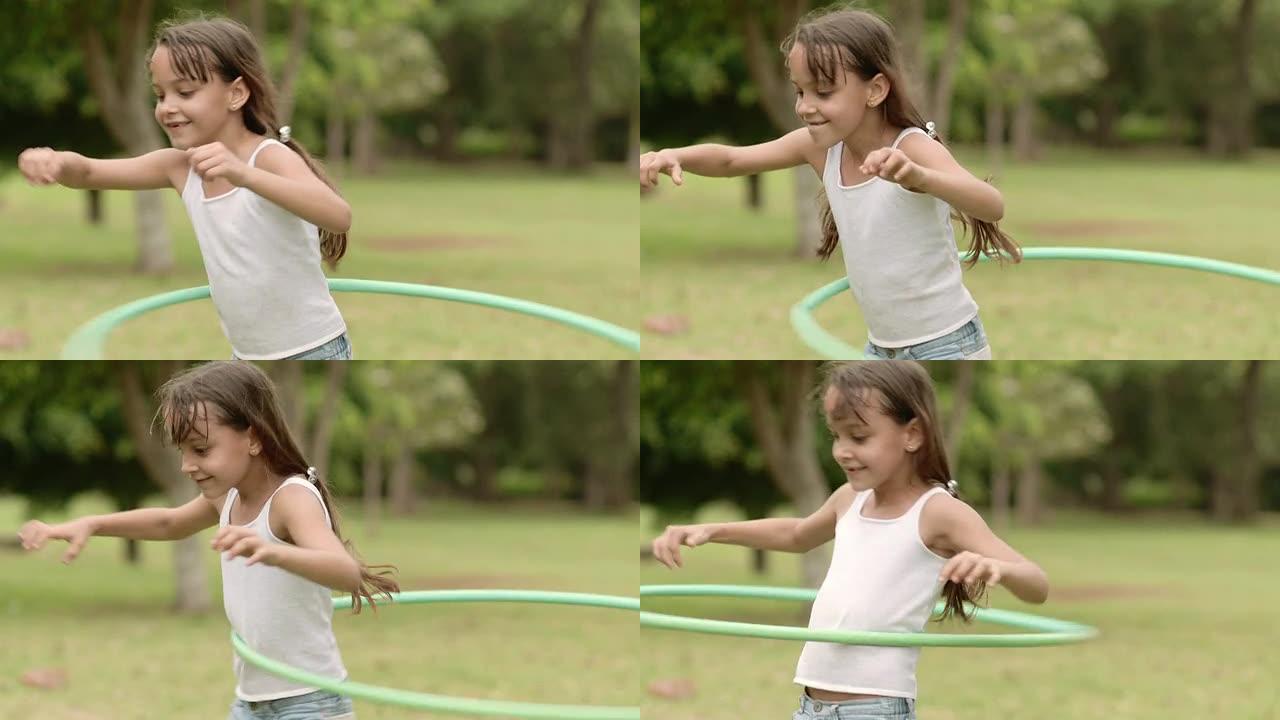 快乐的小女孩在公园玩呼啦圈