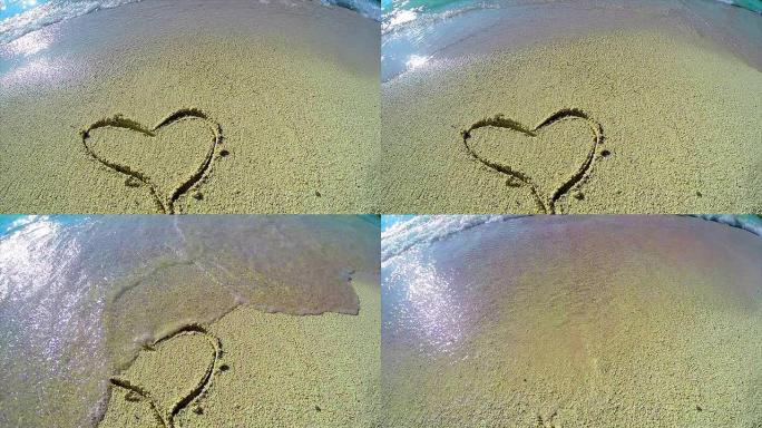 用海沫和波浪在沙滩上画的心，慢动作