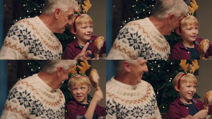 爷爷和孙子一起享受圣诞大餐，吃美味的家常便饭，在家与家人分享节日大餐4k镜头