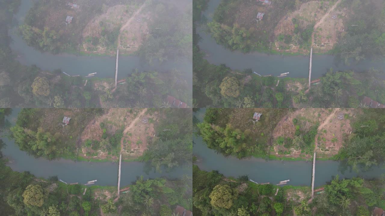 雾中日出时湄公河宁静景象的鸟瞰图
