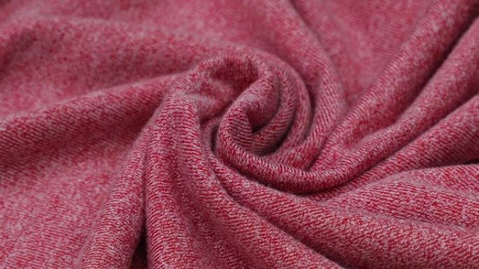 粉色织物背景。粉色布波浪背景纹理。粉色织物布纺织材料。