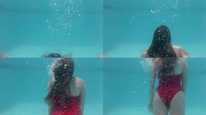 美丽的女人在游泳池水下游泳漂浮在蓝色水晶清澈的水中，夏天穿着性感的红色泳衣4k，玩得开心