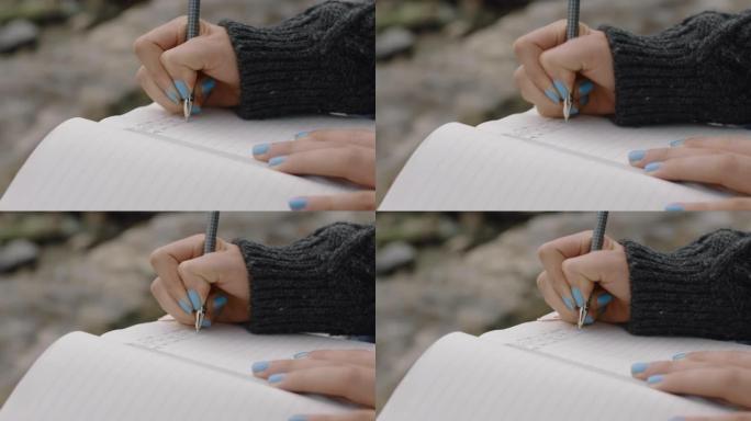 亲密的手女人在日记日记中写作少女在海边海滩上表达孤独的想法