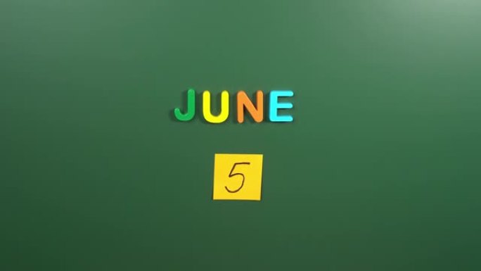 6月5日日历日用手在学校董事会上贴一张贴纸。5 6月日期。6月的第五天。第5个日期号。5天日历。五次