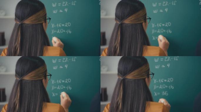 女老师在学校上写数学方程式，教育过程，工作