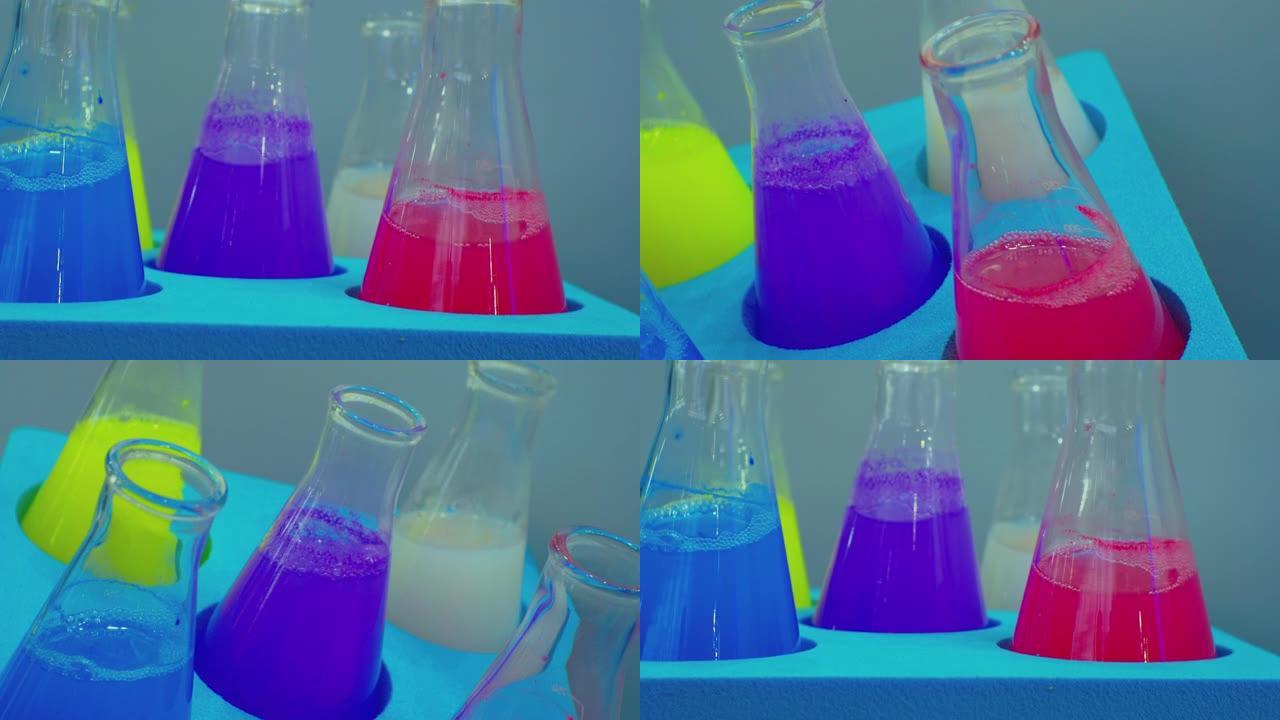 几个相同的玻璃试管，将不同颜色的彩色液体倒入摇床中缓慢旋转