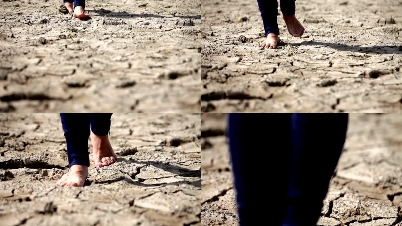 高清: 赤脚人在裂开的土壤上行走