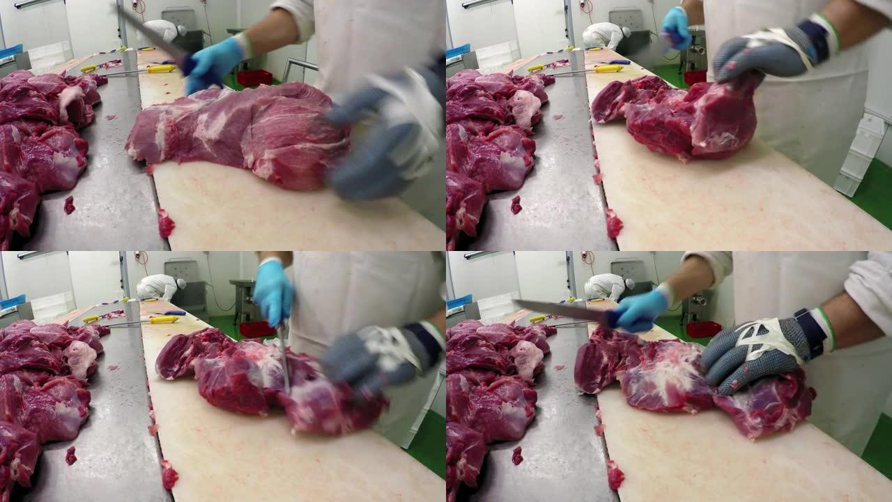 在肉类加工厂切割抗割肉手套的工人