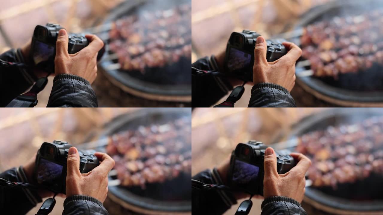 男人在烤架上拍下美味的shashlik的照片