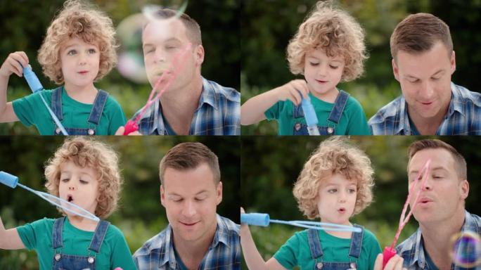 父亲和儿子一起在阳光明媚的公园吹肥皂泡可爱的小男孩玩得开心爸爸和孩子玩得很开心，享受夏天4k