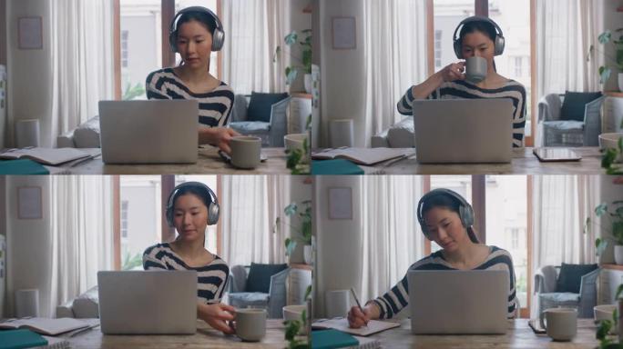 年轻的亚洲女子使用笔记本电脑在家工作，学生头脑风暴项目，网上研究信息，喝咖啡，享受学习