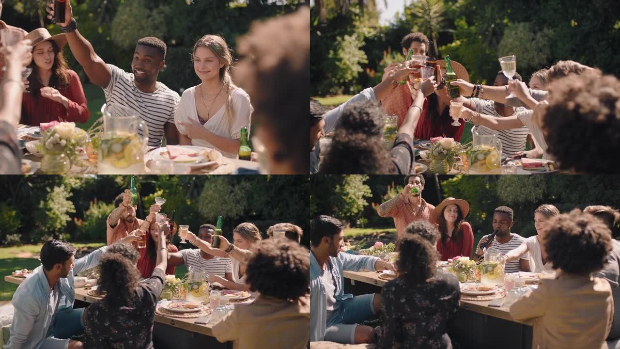 快乐的一群朋友庆祝烤面包玩得开心花园聚会团圆庆祝坐在餐桌旁享受午餐在阳光明媚的周末一起放松
