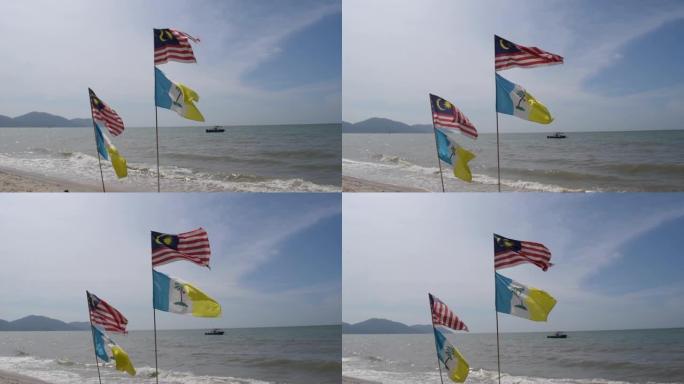 马来西亚和槟岛的旗帜在海滩上。