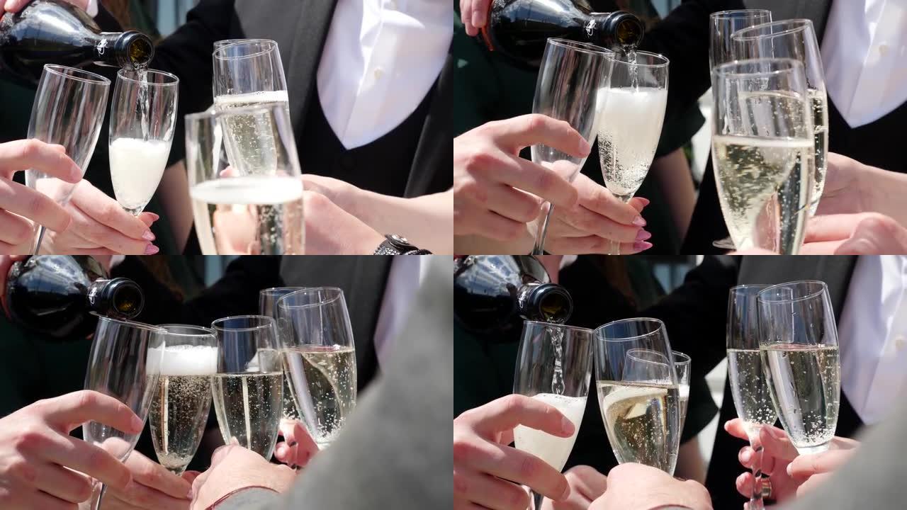 为纪念新娘和新郎的婚礼，将起泡的香槟倒入玻璃杯中并喝醉。婚礼庆典。婚礼庆典的传统和习俗。