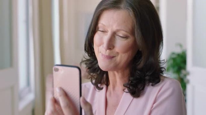 聋哑妇女手持智能手机进行视频聊天，使用手语聋哑祖母挥舞着享受手机上的连接聊天