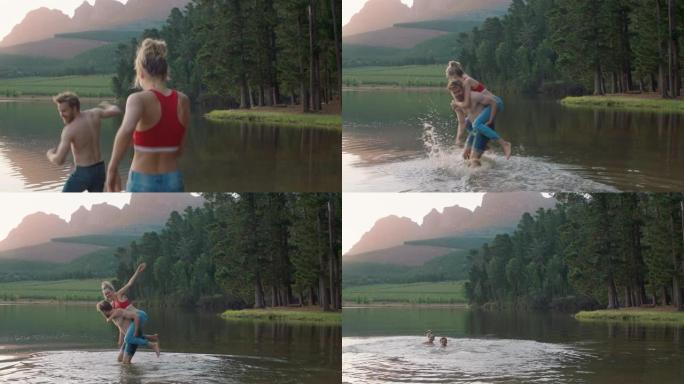 日落时分，快乐的情侣在湖里嬉水，年轻人拿起女朋友在水里嬉水，玩有趣的游戏，享受浪漫的夏日爱情