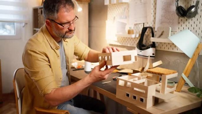 高加索建筑师观察他制作的建筑模型
