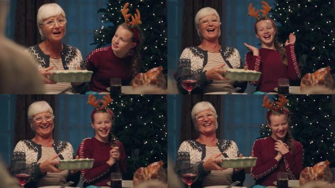 祖母享受圣诞晚餐，孙女吃美味的自制餐，与家人在家分享节日盛宴4k镜头