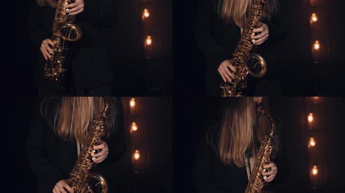 年轻女孩在黑色背景下演奏萨克斯管。特写。电影视图
