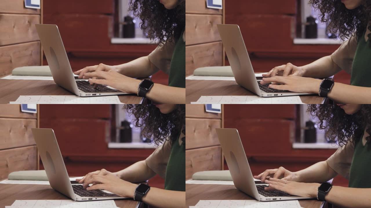 匿名女性在笔记本电脑上打字的手