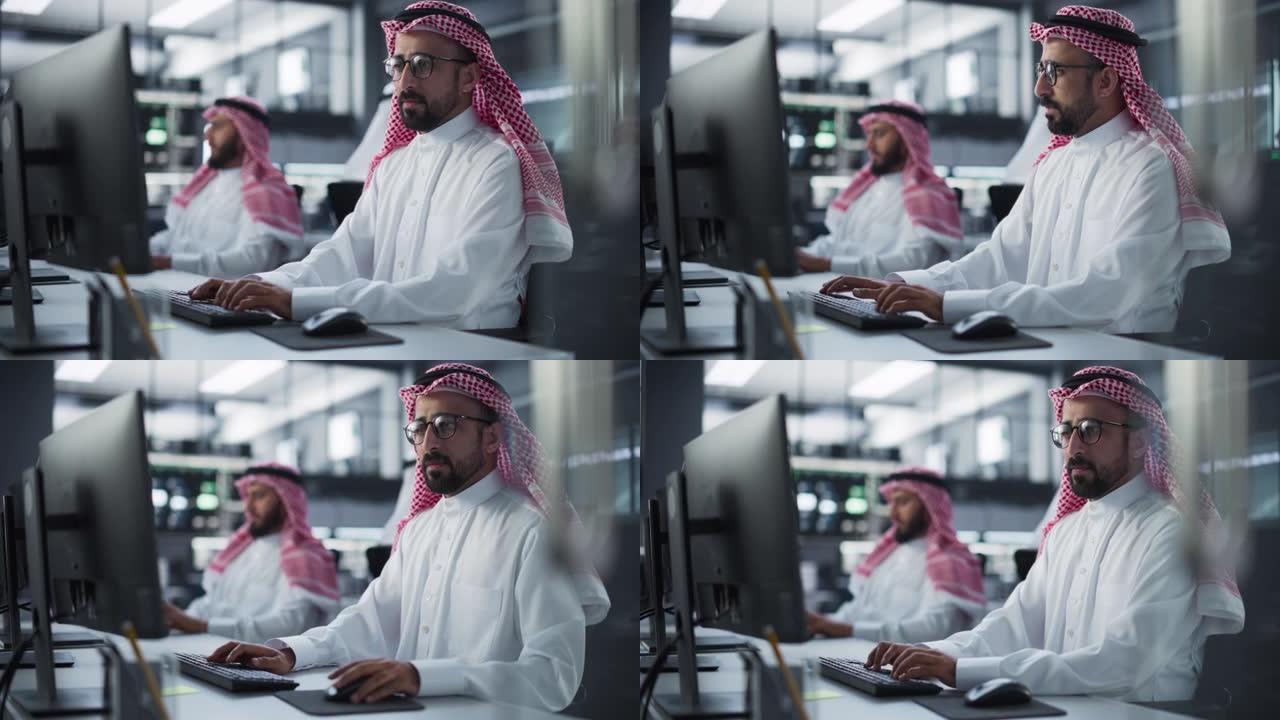 一位体贴的中东工程师在一家科技公司办公室的电脑上工作的肖像。经理与同事合作创新互联网和软件作为服务项