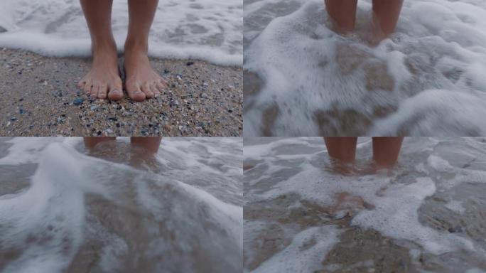 近脚浪飞溅赤脚女子站在海滩上享受清新的海洋海滨度假