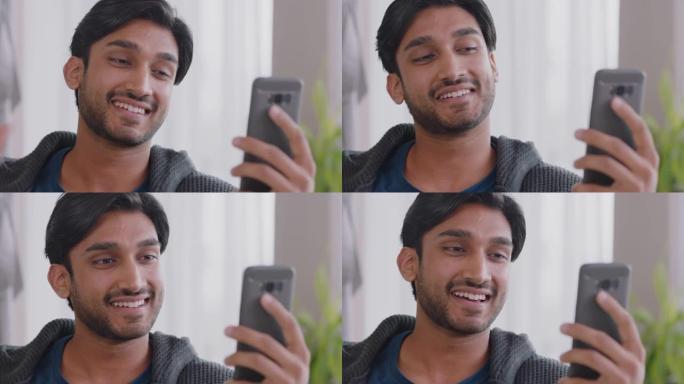快乐的印度男子使用智能手机与朋友在手机上聊天享受视频聊天