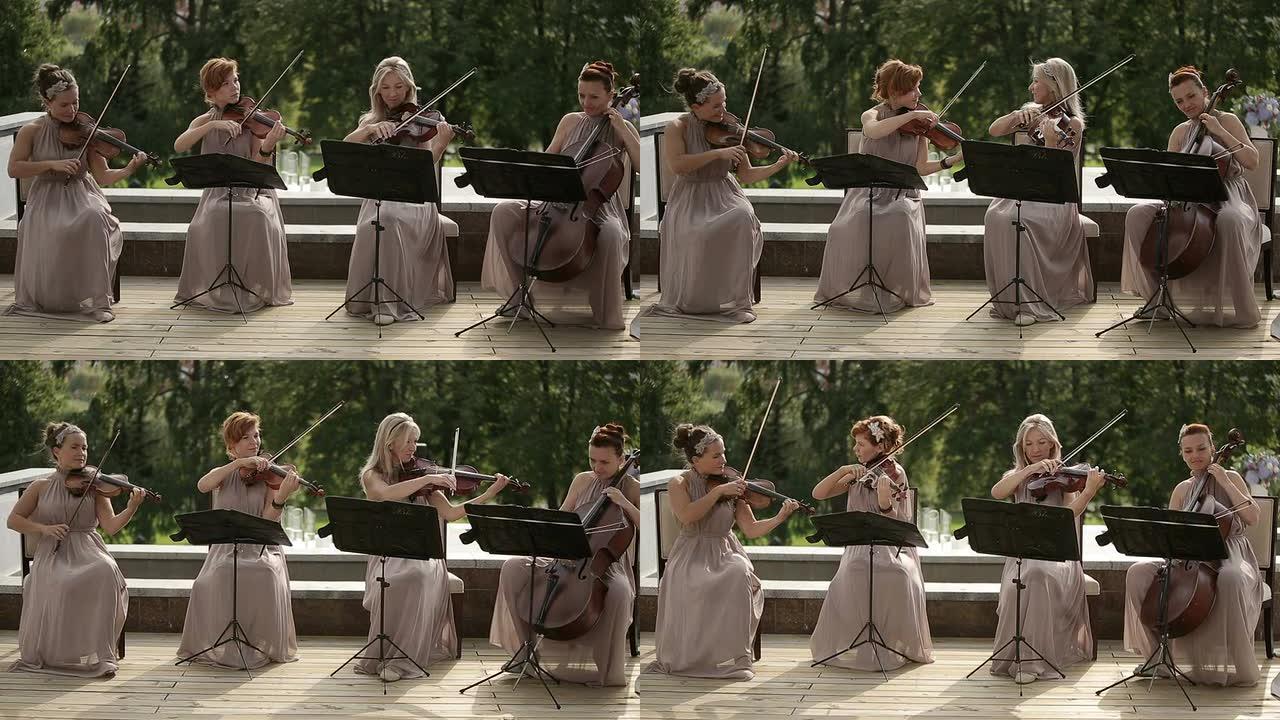 音乐四重奏。三位小提琴家和大提琴家演奏音乐。