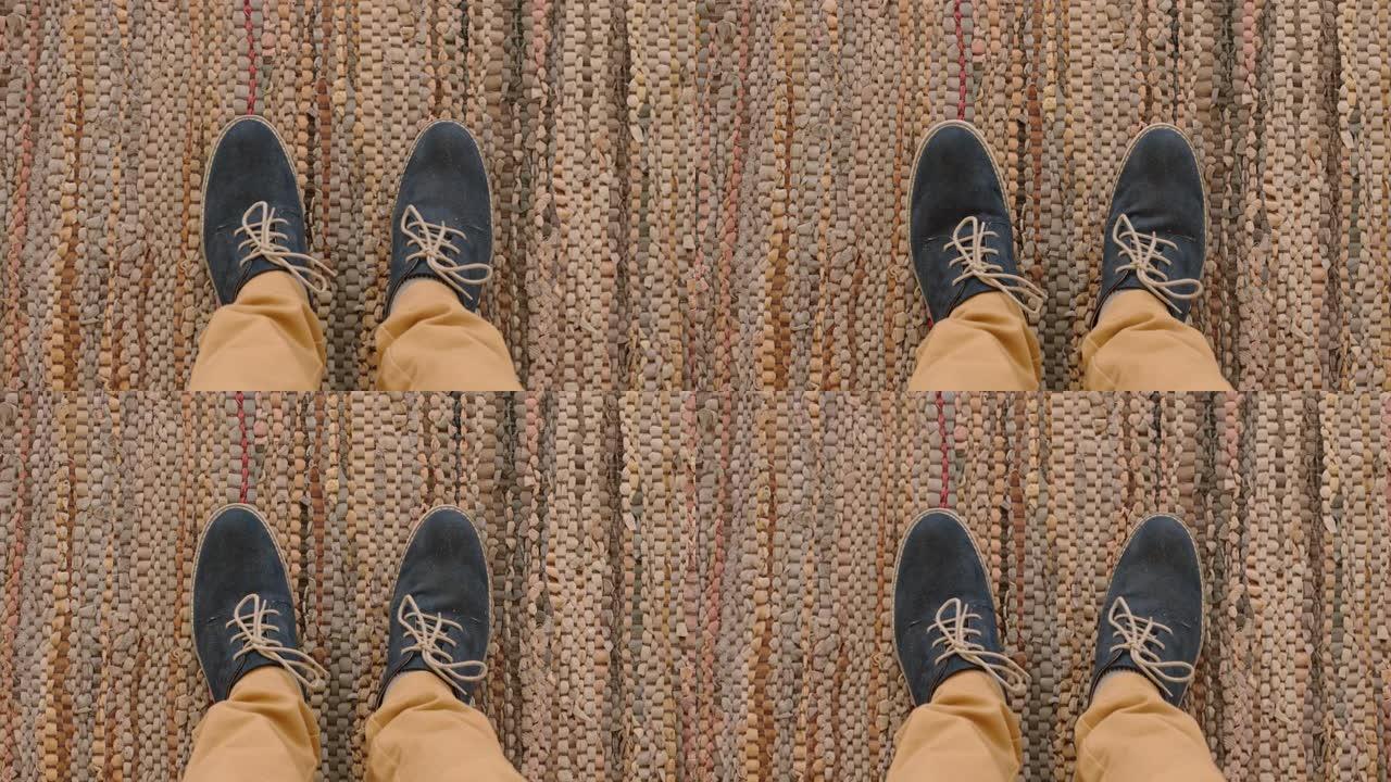 顶视图男人穿着鞋子，站在地毯上享受时尚的脚