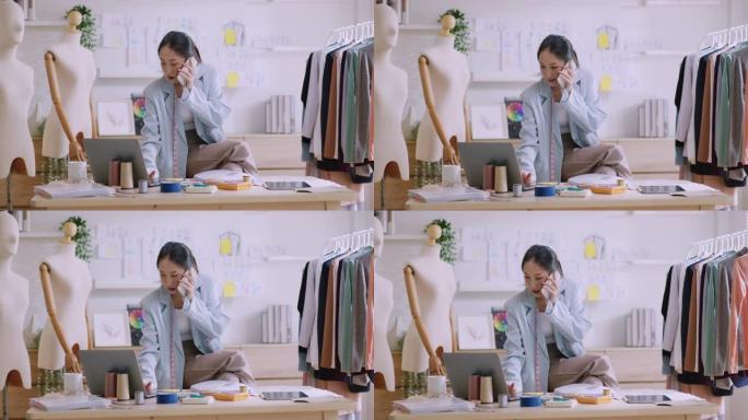 年轻的亚洲自由时装设计师在她的时装工作室工作